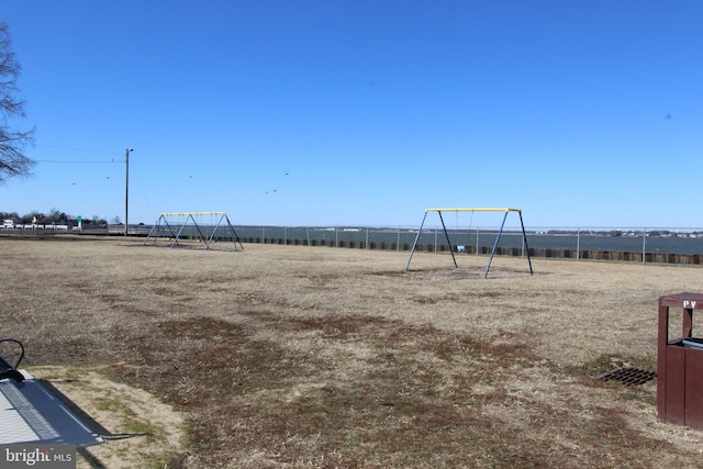 view of yard with playground community and fence