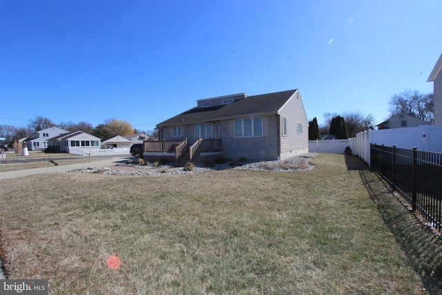 view of front of home with crawl space, a fenced backyard, and a front yard