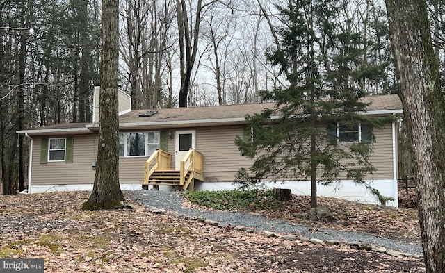 view of front of home featuring a chimney