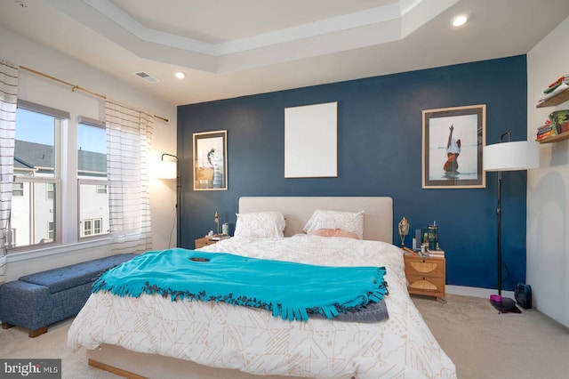 carpeted bedroom with recessed lighting, a raised ceiling, visible vents, an accent wall, and baseboards