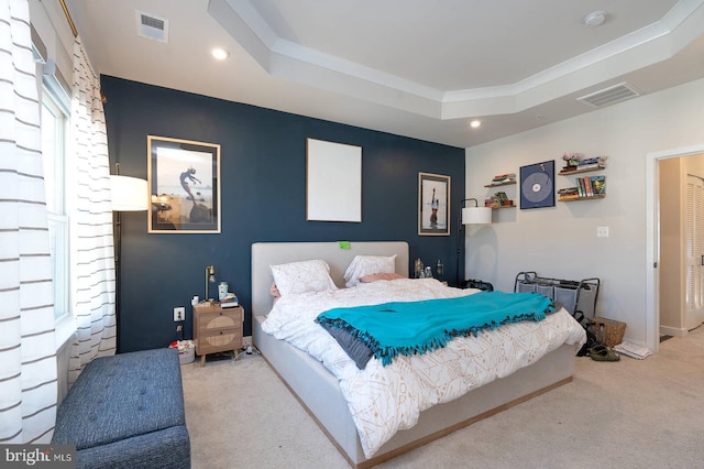 carpeted bedroom with recessed lighting, a raised ceiling, and visible vents