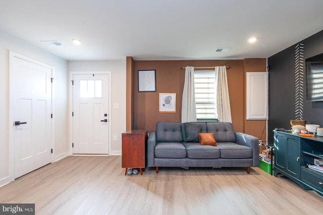 living area featuring recessed lighting, light wood-type flooring, visible vents, and baseboards