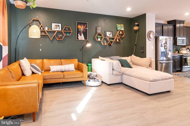 living room with light wood-style flooring and recessed lighting