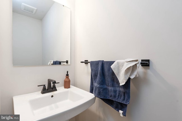 bathroom featuring visible vents and a sink