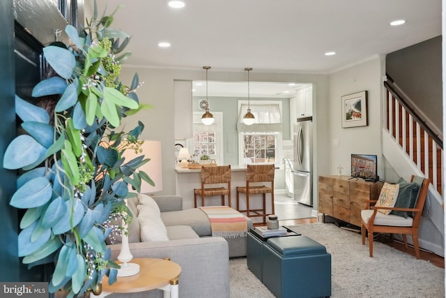 living room with light wood-style flooring, stairway, recessed lighting, and ornamental molding