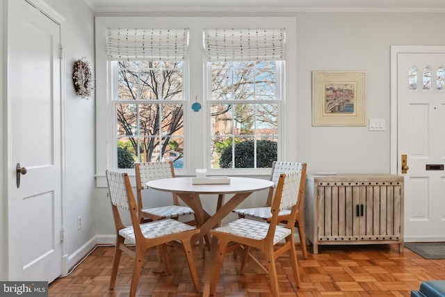 dining area with radiator heating unit, baseboards, plenty of natural light, and ornamental molding