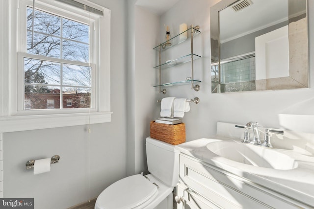 bathroom featuring visible vents, toilet, and vanity