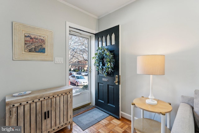 entryway with baseboards and ornamental molding