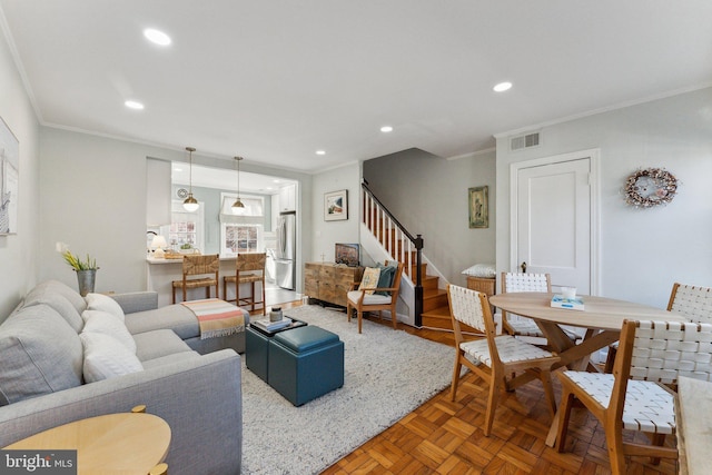 living room featuring stairs, recessed lighting, visible vents, and ornamental molding