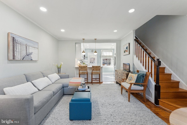 living room featuring stairway, recessed lighting, crown molding, and baseboards