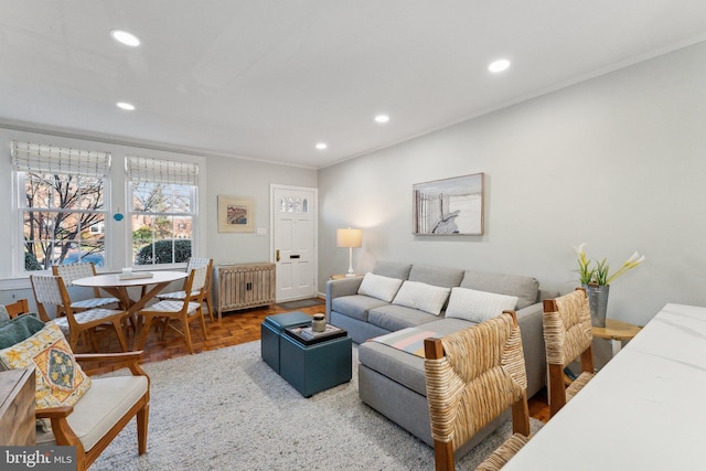 living room with recessed lighting, crown molding, and radiator heating unit