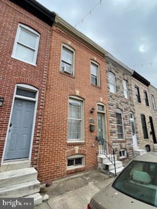 view of front facade featuring brick siding and entry steps