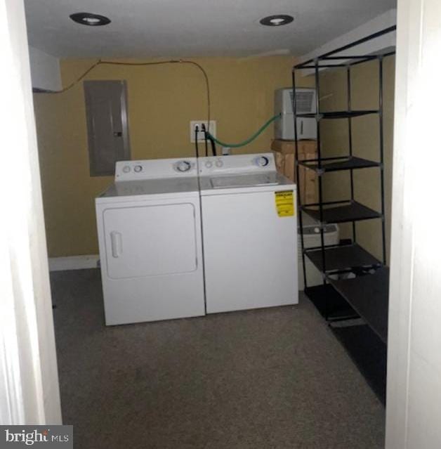 laundry area featuring laundry area, electric panel, and washer and clothes dryer