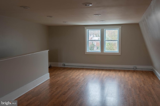 spare room with wood finished floors and baseboards