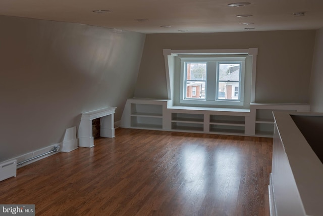 bonus room with baseboards and wood finished floors