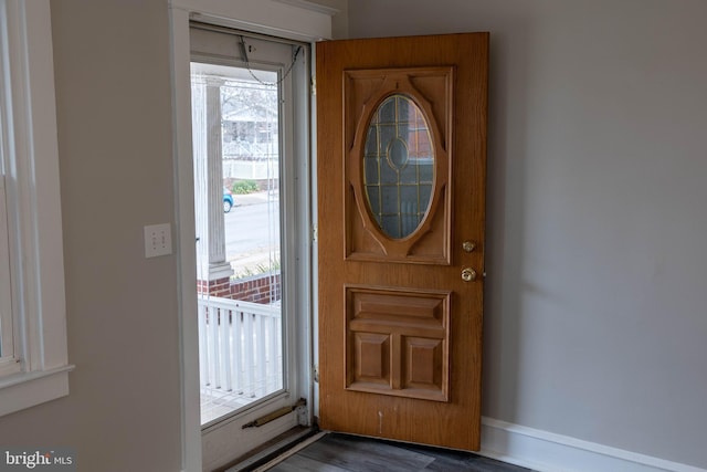 foyer entrance featuring dark wood-style floors