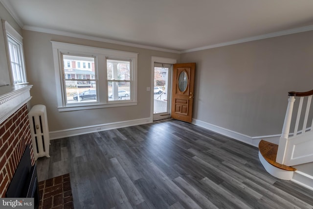 entrance foyer with stairs, dark wood-type flooring, crown molding, and baseboards