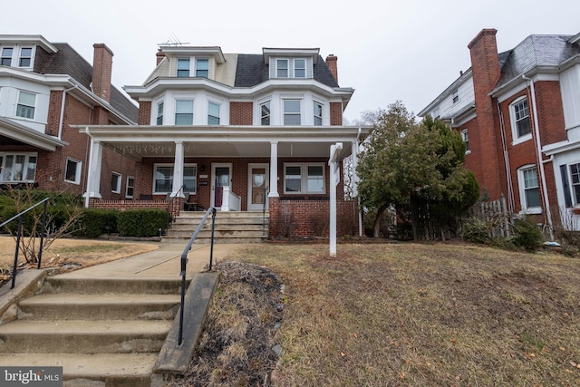 view of front of property featuring covered porch and brick siding