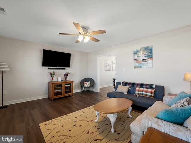 living room with visible vents, wood finished floors, a ceiling fan, and baseboards