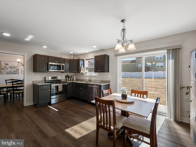 dining room with baseboards, dark wood-type flooring, and recessed lighting