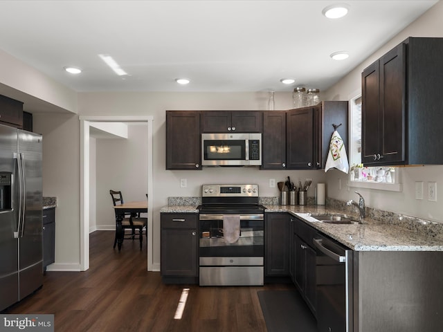 kitchen with dark wood-style floors, dark brown cabinets, stainless steel appliances, and a sink