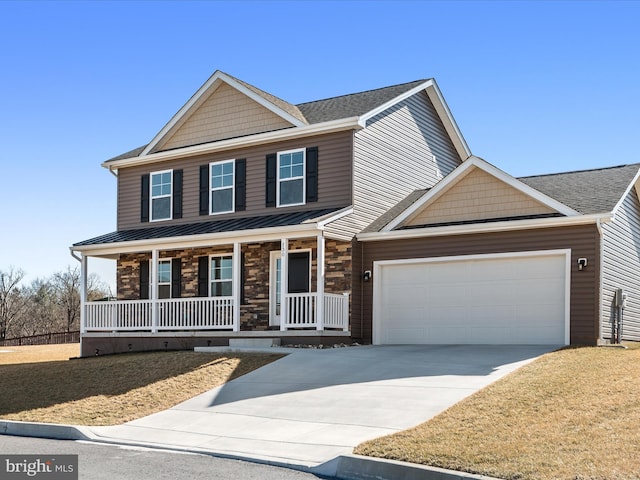 view of front of home featuring a porch, an attached garage, driveway, stone siding, and a standing seam roof