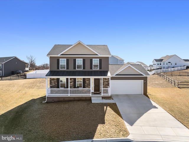 view of front of house featuring a porch, an attached garage, fence, driveway, and a standing seam roof