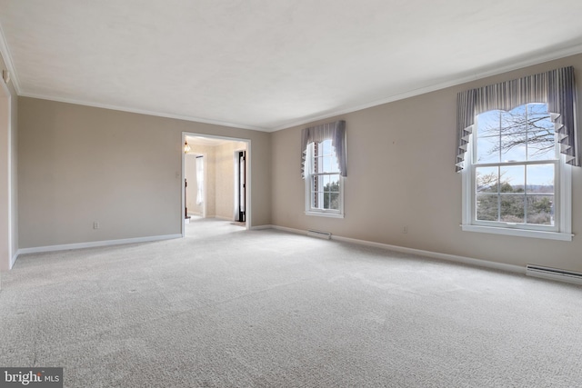 spare room with ornamental molding, carpet, a baseboard heating unit, and baseboards