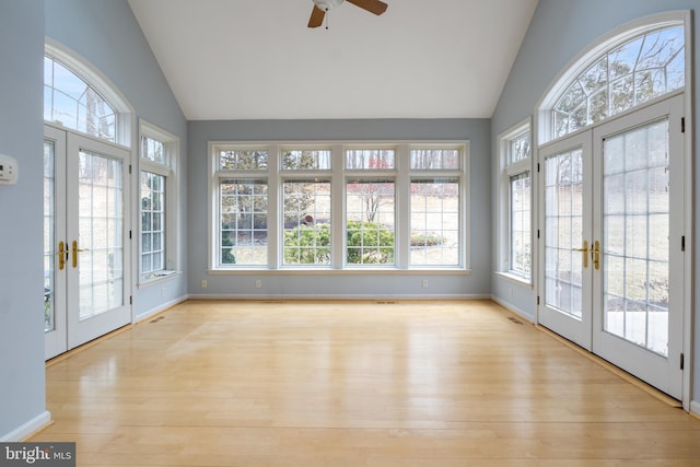 unfurnished sunroom featuring lofted ceiling, french doors, and visible vents