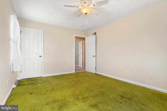 unfurnished bedroom featuring carpet flooring, ceiling fan, visible vents, and baseboards