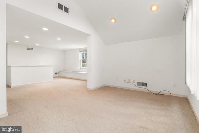 empty room with recessed lighting, visible vents, vaulted ceiling, and light colored carpet