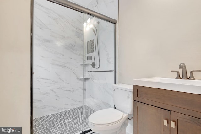 bathroom featuring visible vents, vanity, a marble finish shower, and toilet