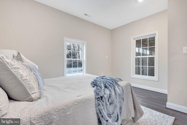 bedroom with baseboards, visible vents, wood finished floors, and recessed lighting