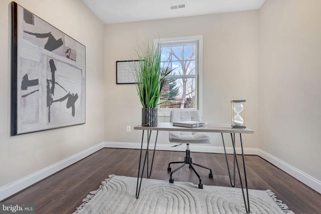 office featuring wood finished floors, visible vents, and baseboards