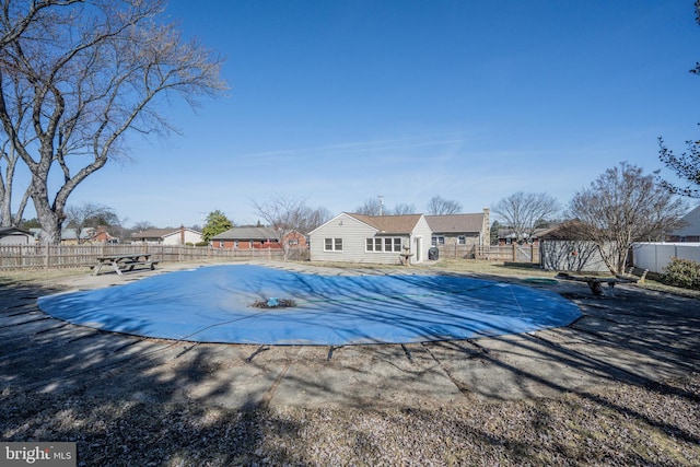 view of pool featuring an outbuilding, a fenced backyard, a fenced in pool, and a patio