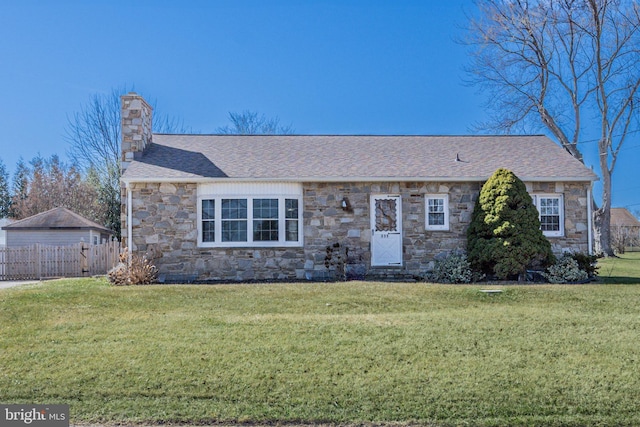 single story home featuring a front yard, fence, a shingled roof, a chimney, and stone siding