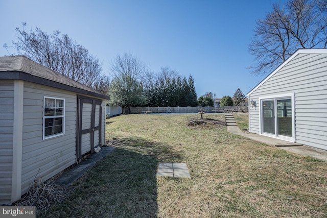 view of yard featuring an outdoor structure and a fenced backyard