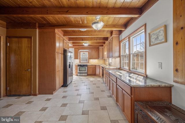 kitchen featuring beamed ceiling, a sink, appliances with stainless steel finishes, wooden ceiling, and light stone countertops