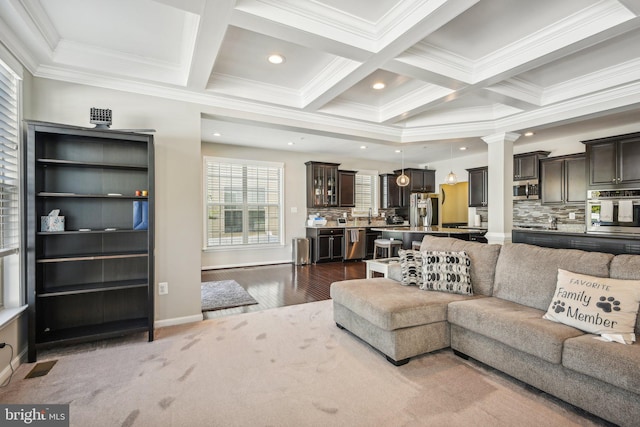 living area featuring ornamental molding, recessed lighting, coffered ceiling, and beamed ceiling