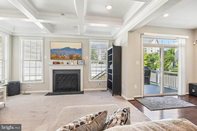 living area with coffered ceiling, beamed ceiling, plenty of natural light, and a fireplace with flush hearth