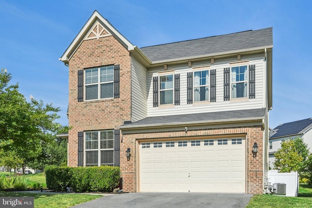 view of front of home with brick siding, roof with shingles, an attached garage, and aphalt driveway