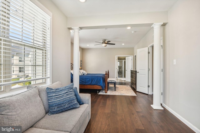 bedroom with dark wood-style floors, recessed lighting, decorative columns, and baseboards