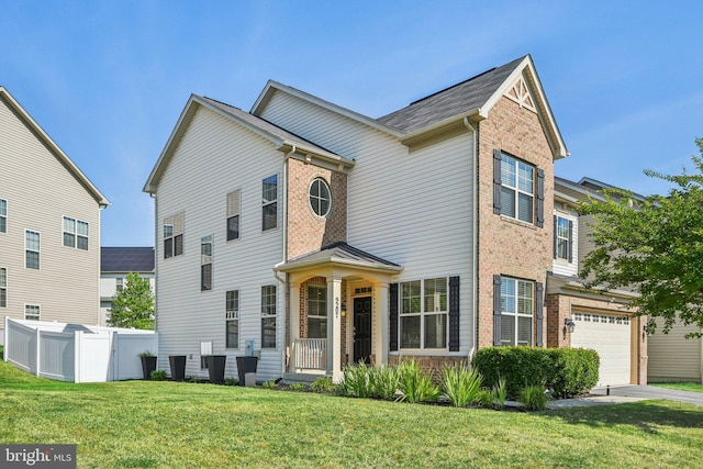 view of front of property with a front yard, brick siding, fence, and driveway