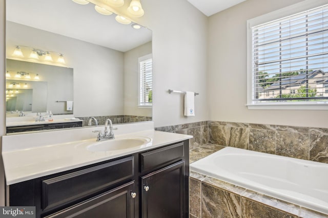 bathroom with a bath and vanity