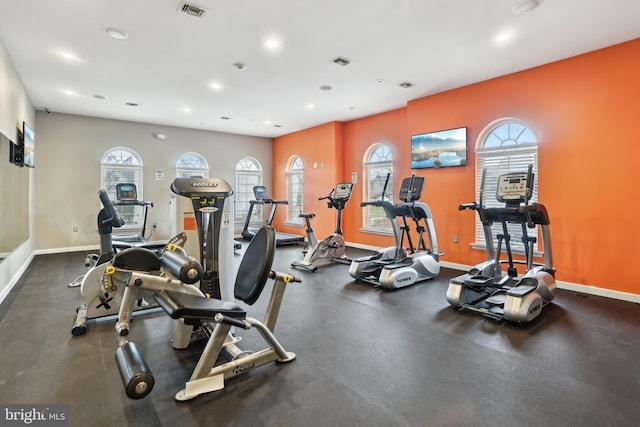 workout area featuring plenty of natural light, baseboards, and visible vents