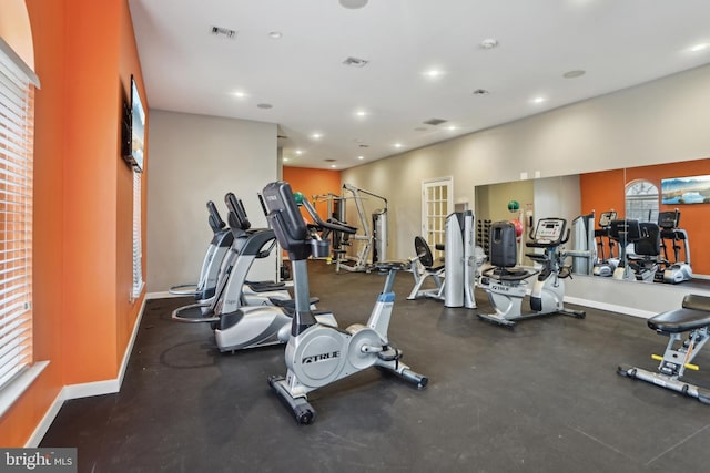 exercise room with recessed lighting, visible vents, and baseboards