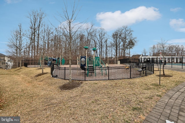 community play area with a yard and fence