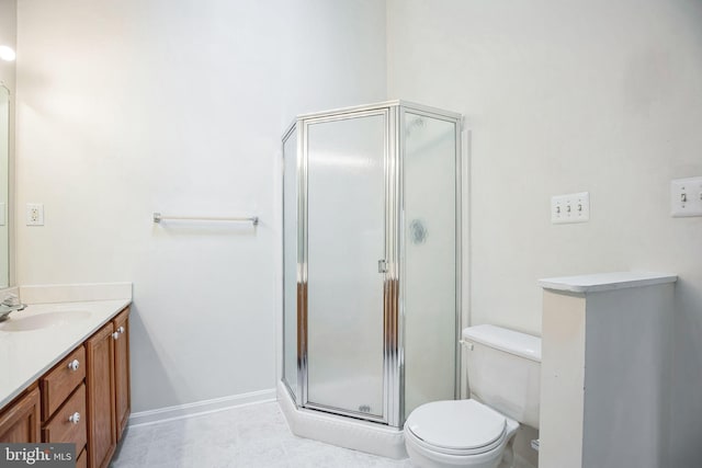 full bathroom with baseboards, vanity, a shower stall, and toilet