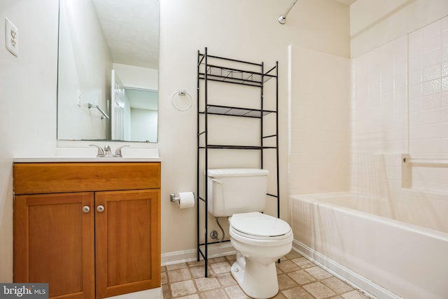 full bathroom featuring baseboards, washtub / shower combination, toilet, tile patterned floors, and vanity