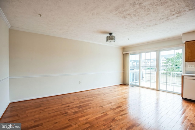 spare room featuring light wood-type flooring, baseboards, a textured ceiling, and ornamental molding